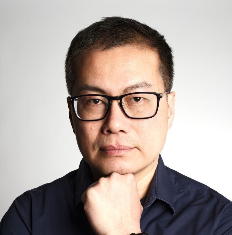 Confident businessman posing in a studio with a thoughtful expression. Perfect for corporate or professional use.